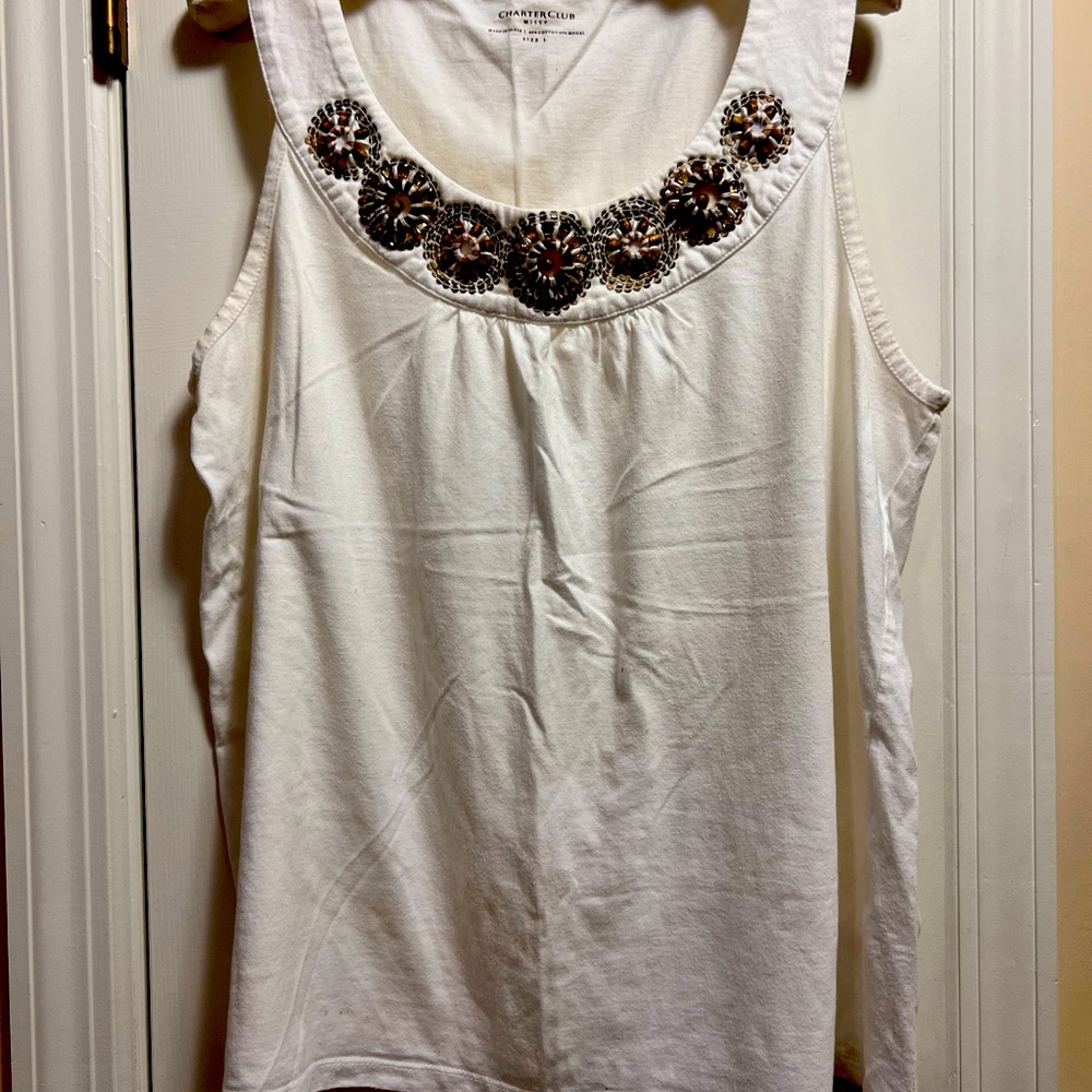 Sleeveless white top with embellished neckline